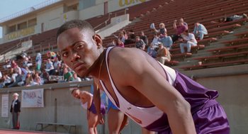 Movie still from “Higher Learning” (1995), directed by John Singleton – A man standing in front of an audience in front of bleachers; Close Up shot, Low angle