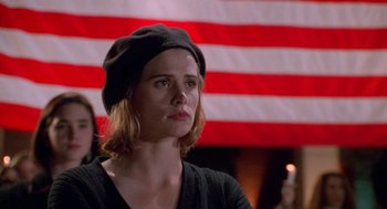 Movie still from “Higher Learning” (1995), directed by John Singleton – A woman wearing a black hat in front of an american flag; Close Up shot, Low angle