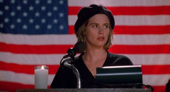 Movie still from “Higher Learning” (1995), directed by John Singleton – A woman in a black hat is speaking at a microphone; Close Up shot, Low angle