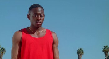 Movie still from “Higher Learning” (1995), directed by John Singleton – A man in a red tank top is looking at the camera; Close Up shot, Low angle