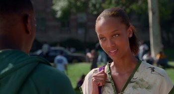 Movie still from “Higher Learning” (1995), directed by John Singleton – A beautiful young woman standing next to a park; Close Up shot, Over the shoulder angle