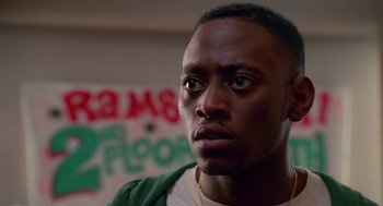 Movie still from “Higher Learning” (1995), directed by John Singleton – A person wearing a green shirt; Close Up shot, Low angle