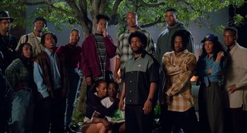Movie still from “Higher Learning” (1995), directed by John Singleton – A group of people standing next to a tree; Wide shot, High angle