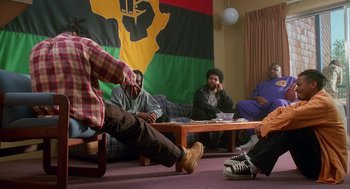 Movie still from “Higher Learning” (1995), directed by John Singleton – A group of people sitting around a table; Wide shot, Low angle