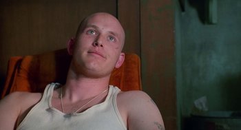 Movie still from “Higher Learning” (1995), directed by John Singleton – A man with a bald head sitting in a chair looking up; Close Up shot, Low angle