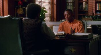 Movie still from “Higher Learning” (1995), directed by John Singleton – Two men sitting at a desk in front of a mirror; Medium shot, Over the shoulder angle