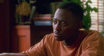 Movie still from “Higher Learning” (1995), directed by John Singleton – A person wearing an orange t - shirt; Close Up shot, Over the shoulder angle