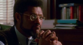 Movie still from “Higher Learning” (1995), directed by John Singleton – A man in a suit and tie with glasses; Close Up shot, Low angle