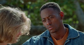Movie still from “Higher Learning” (1995), directed by John Singleton – A man with a beard and a jacket looking at the camera; Close Up shot, Over the shoulder angle