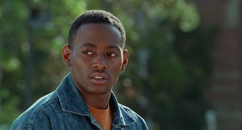 Movie still from “Higher Learning” (1995), directed by John Singleton – A person wearing a jean shirt; Close Up shot, Low angle