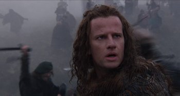 Movie still from “Highlander” (1986), directed by Russell Mulcahy – A person with long hair; Close Up shot, Low angle