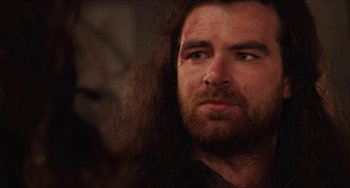 Movie still from “Highlander” (1986), directed by Russell Mulcahy – A person with long hair; Close Up shot, Over the shoulder angle