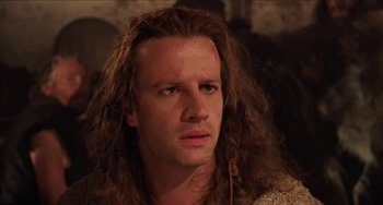 Movie still from “Highlander” (1986), directed by Russell Mulcahy – A person with long brown hair; Close Up shot, Over the shoulder angle