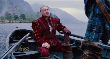 Movie still from “Highlander” (1986), directed by Russell Mulcahy – A man sitting in a boat on the water; Medium shot, Over the shoulder angle