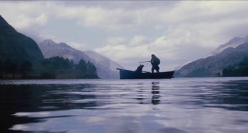 Movie still from “Highlander” (1986), directed by Russell Mulcahy – Two people in a boat on a body of water; Extreme Wide shot, Low angle