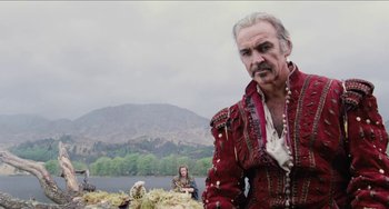 Movie still from “Highlander” (1986), directed by Russell Mulcahy – A man that is wearing a red jacket; Medium shot, Low angle