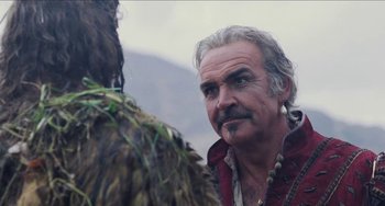 Movie still from “Highlander” (1986), directed by Russell Mulcahy – An older man with a beard is looking at another man; Close Up shot, Over the shoulder angle