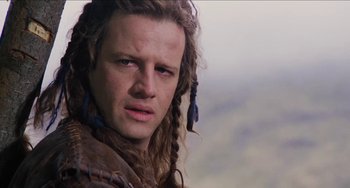Movie still from “Highlander” (1986), directed by Russell Mulcahy – A person with long dreadlocks; Close Up shot, Over the shoulder angle