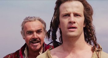 Movie still from “Highlander” (1986), directed by Russell Mulcahy – A man and a woman standing next to each other; Close Up shot, Over the shoulder angle