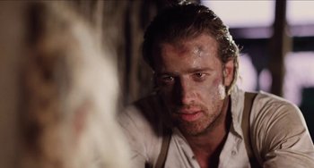 Movie still from “Highlander” (1986), directed by Russell Mulcahy – A person wearing a white shirt; Close Up shot, Over the shoulder angle