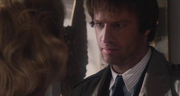 Movie still from “Highlander” (1986), directed by Russell Mulcahy – A person wearing a suit and a tie; Close Up shot, Over the shoulder angle