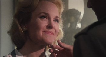 Movie still from “Highlander” (1986), directed by Russell Mulcahy – A person putting makeup on her face; Close Up shot, Over the shoulder angle