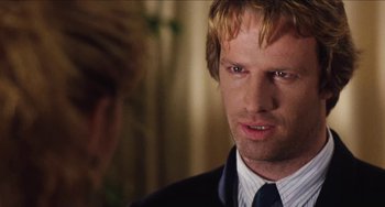 Movie still from “Highlander” (1986), directed by Russell Mulcahy – A person wearing a suit and tie; Close Up shot, Over the shoulder angle