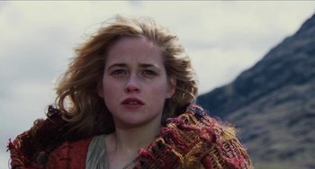 Movie still from “Highlander” (1986), directed by Russell Mulcahy – A person holding a scarf; Close Up shot, Low angle