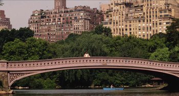 Movie still from “Highlander” (1986), directed by Russell Mulcahy – Two people are sitting on a bridge over a body of water; Extreme Wide shot, High angle