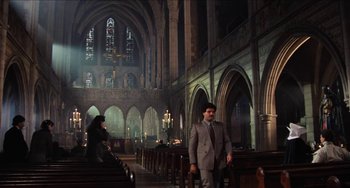 Movie still from “Highlander” (1986), directed by Russell Mulcahy – A man in a suit standing in a church; Extreme Wide shot, High angle