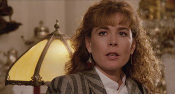 Movie still from “Highlander” (1986), directed by Russell Mulcahy – A person wearing a suit and tie; Close Up shot, Over the shoulder angle