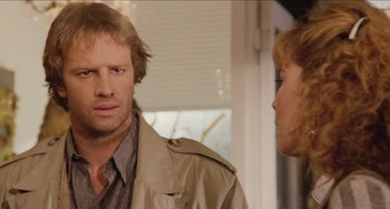 Movie still from “Highlander” (1986), directed by Russell Mulcahy – A man and a woman standing next to each other in front of a window; Close Up shot, Over the shoulder angle