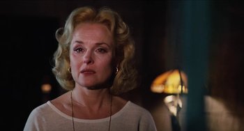 Movie still from “Highlander” (1986), directed by Russell Mulcahy – An older woman with blonde curly hair wearing a white shirt; Close Up shot, Low angle