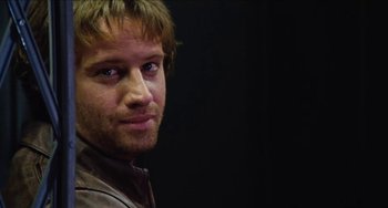 Movie still from “Highlander” (1986), directed by Russell Mulcahy – A person wearing a leather jacket; Close Up shot, Over the shoulder angle