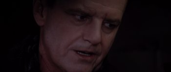 Movie still from “Hoffa” (1992), directed by Danny DeVito – A man's face in a dimly - lit room; Close Up shot, Over the shoulder angle