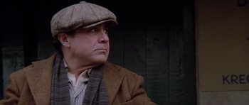 Movie still from “Hoffa” (1992), directed by Danny DeVito – A man wearing a hat and a jacket; Close Up shot, Low angle