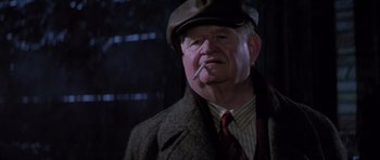 Movie still from “Hoffa” (1992), directed by Danny DeVito – An older man wearing a hat and smoking a cigarette; Close Up shot, Low angle