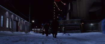 Movie still from “Hoffa” (1992), directed by Danny DeVito – Two people walking on a snowy sidewalk at night; Extreme Wide shot, Low angle