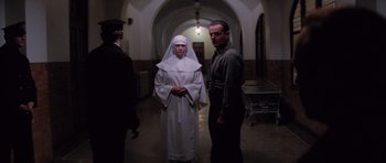 Movie still from “Hoffa” (1992), directed by Danny DeVito – Two men and a woman dressed as a nun; Wide shot, Low angle