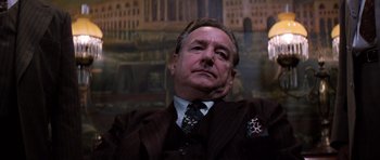 Movie still from “Hoffa” (1992), directed by Danny DeVito – An older man wearing a suit and tie; Close Up shot, Low angle