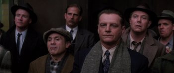 Movie still from “Hoffa” (1992), directed by Danny DeVito – A group of men standing next to each other; Medium shot, Low angle