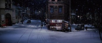 Movie still from “Hoffa” (1992), directed by Danny DeVito – A snowy street with a building in the background; Extreme Wide shot, High angle