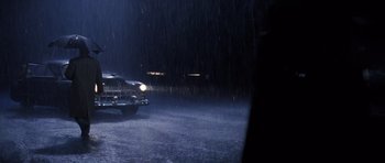 Movie still from “Hoffa” (1992), directed by Danny DeVito – A car is driving in the rain at night; Extreme Wide shot, High angle