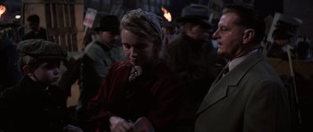 Movie still from “Hoffa” (1992), directed by Danny DeVito – A group of people standing around each other in the dark; Medium shot, Over the shoulder angle