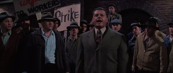 Movie still from “Hoffa” (1992), directed by Danny DeVito – A group of men standing next to each other in suits; Medium shot, High angle