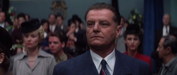 Movie still from “Hoffa” (1992), directed by Danny DeVito – A man in a suit and a tie; Close Up shot, Low angle