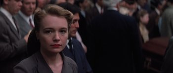 Movie still from “Hoffa” (1992), directed by Danny DeVito – A woman standing in a crowd of people; Close Up shot, Low angle