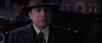 Movie still from “Hoffa” (1992), directed by Danny DeVito – A person wearing a suit and hat; Close Up shot, Low angle