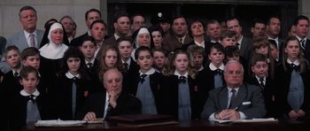 Movie still from “Hoffa” (1992), directed by Danny DeVito – A large group of people sitting in front of a table; Medium shot, High angle