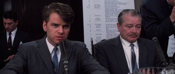 Movie still from “Hoffa” (1992), directed by Danny DeVito – A man in a suit and tie sitting next to another man in a suit and tie; Close Up shot, Over the shoulder angle